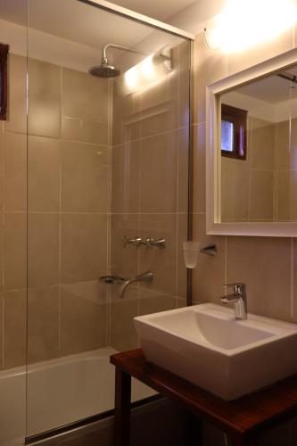 La salle de bains est pourvue d'un lavabo, d'une baignoire et d'un miroir. dans l'établissement Valle Frío Ushuaia, à Ushuaia