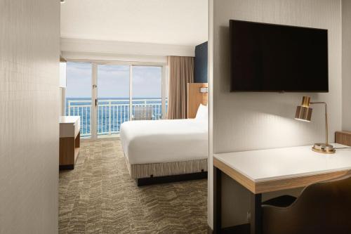 a hotel room with a bed and a large window at SpringHill Suites by Marriott Virginia Beach Oceanfront in Virginia Beach