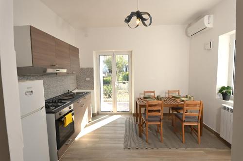 a kitchen with a table and a dining room at Casa Benesere Corpo E Mente in Castel Volturno