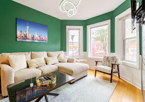 a living room with green walls and a couch at 2 Bed Apt w/ Office, Free Parking, Near Wrigley in Chicago