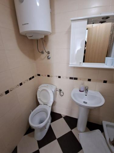 a bathroom with a toilet and a sink at Belveder Montenegro in Rafailovici