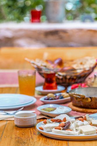 a wooden table topped with plates of food and drinks at Ha La Bodrum in Bodrum City