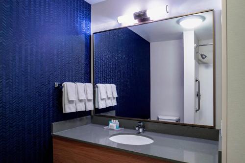a bathroom with a sink and a mirror at Fairfield Inn & Suites by Marriott Kelowna in Kelowna