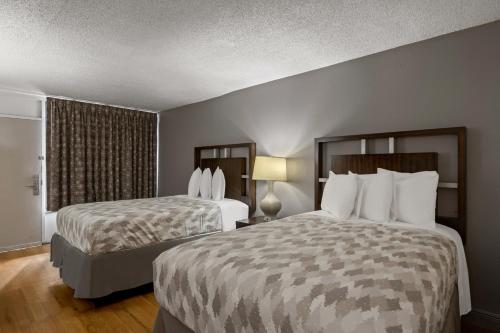 Cama o camas de una habitación en Americas Best Value Inn Orlando, FL