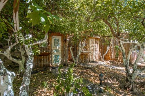 a house with trees in the middle of a yard at Ha La Bodrum in Bodrum City