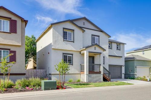 a white house with a porch and a driveway at Spacious Family Home in Stockton - Pets Welcome! in Stockton