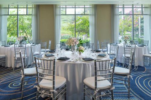 a table set up for a wedding with white tables and chairs at Renaissance ClubSport Aliso Viejo Laguna Beach Hotel in Aliso Viejo