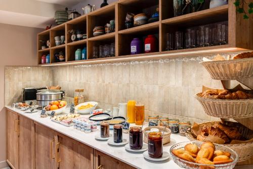 a breakfast buffet with bread and other foods on a counter at Republik Hotel in Lyon
