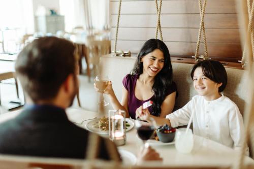 a woman and child sitting at a table in a restaurant at Newport Marriott Hotel & Spa in Newport