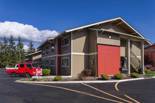 a red truck parked in front of a building at Coachman Inn in Bellingham