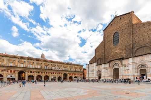 a group of people walking in a plaza in front of a building at ImmoBo Arcadian - Piazza Maggiore View in Bologna