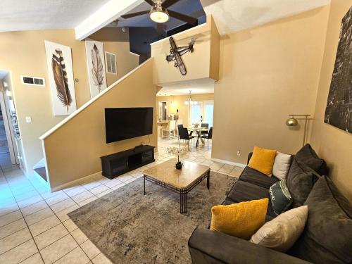 a living room with a couch and a tv at Spacious 2 Bedroom Townhome/ /15 min from downtown in Houston