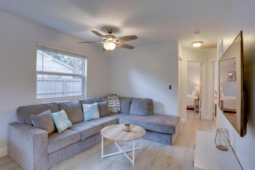 a living room with a couch and a table at Jupiter Townhome with Patio and Yard about 6 Mi to Beach! in Jupiter