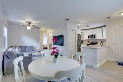 a kitchen and living room with a white table and chairs at Jupiter Townhome with Patio and Yard about 6 Mi to Beach! in Jupiter