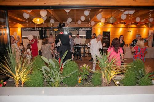 a group of people in a room with plants at Gent's Inn Luxury in Durrës
