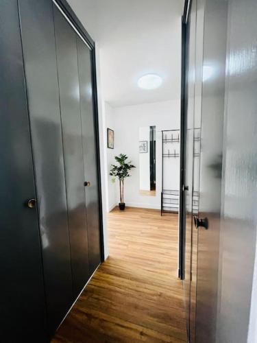 a hallway with a glass door leading to a room at Appartement avec une superbe vue sur la ville in Montargis