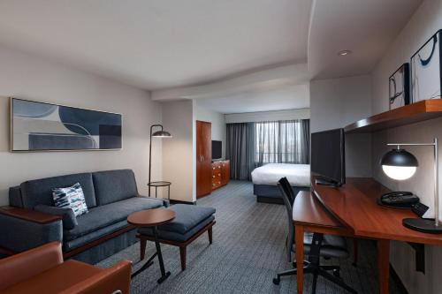a hotel room with a couch and a desk at Courtyard by Marriott Boise West/Meridian in Boise