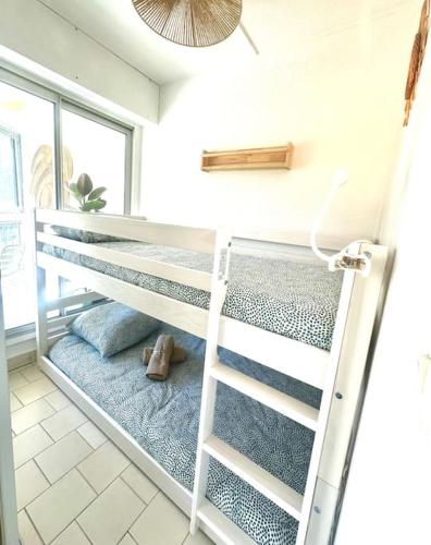- un lit superposé avec une échelle dans une chambre dans l'établissement The Palm 100m de la plage Parking Clim Wifi, à La Grande Motte
