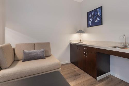 a living room with a couch and a sink at Courtyard by Marriott New York Manhattan / Soho in New York