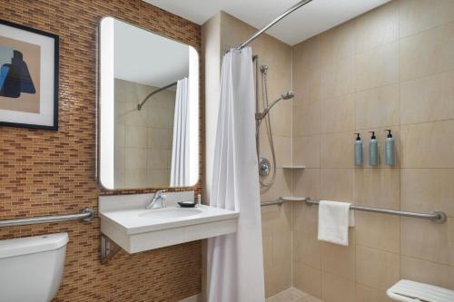 een badkamer met een wastafel, een toilet en een spiegel bij Courtyard by Marriott New York Manhattan / Soho in New York