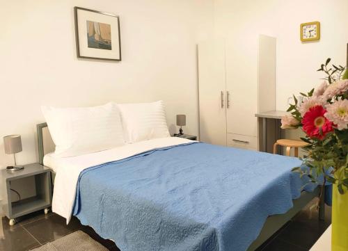a bedroom with a bed with a blue blanket at Rafael Apartments in Medulin