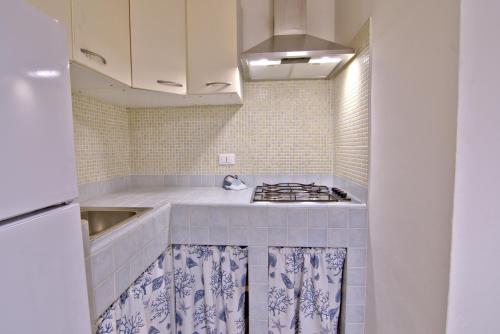 a kitchen with a sink and a stove top oven at Casa Gabriella in Fetovaia