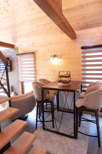 a dining room with a table and chairs at Tara Vista Cabin in Zaovine