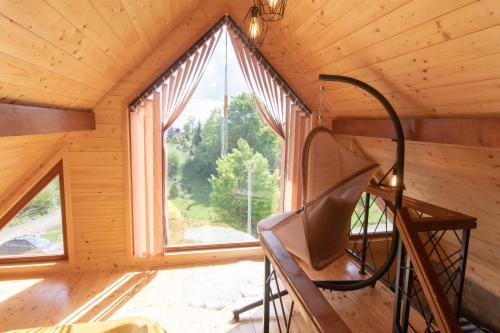 a room with a large window in a cabin at Tara Vista Cabin in Zaovine