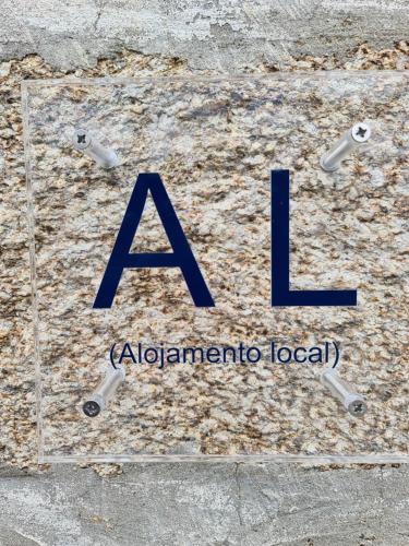 a sign for a albuquerqueoria local with the letter l at Casa Maria da Eira in Arcos de Valdevez