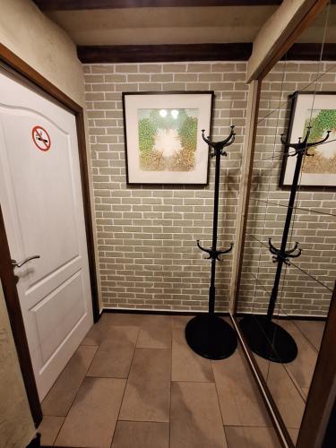 a hallway with three music stands next to a brick wall at WesterOurthe 6 personen Sauna in Durbuy