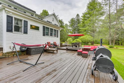 a wooden deck with a hammock and a patio at Hot Tub, Game Room Greentown Home Near State Park in Greentown