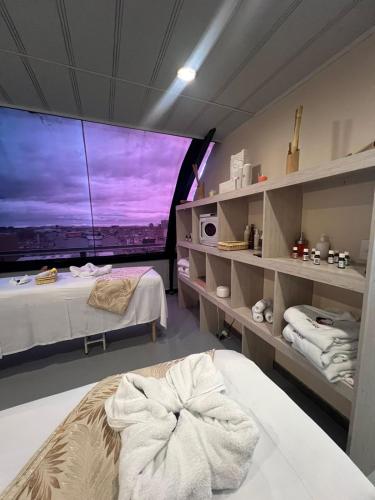 a room with two beds and a large window at Hotel Zensual in Bogotá