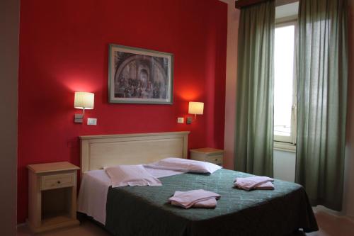 Voodi või voodid majutusasutuse Hotel Genzianella toas