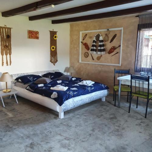 a bedroom with a bed and a table in it at Casa Tiron(Pai) in Gura Humorului