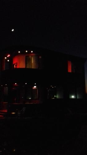 a dark picture of a building at night at Villa Mostafa Sadek, Swimming pool, Tennis & Squash - Borg ElArab Airport Alexandria in Borg El Arab