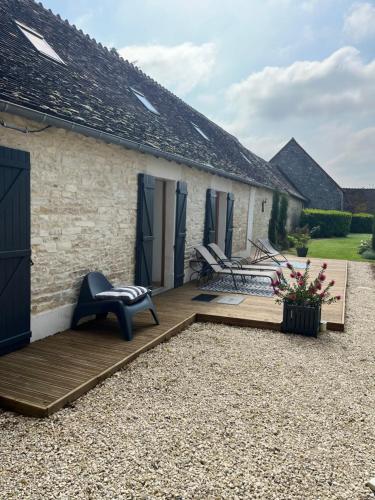 a garden with a wooden deck next to a building at CERES HOME in Montierchaume