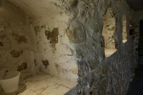 a room with a stone wall and a toilet at Maison vue mer a 5 min de MONACO in Roquebrune-Cap-Martin