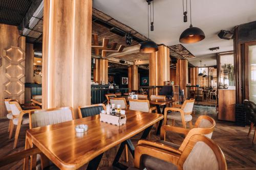 a restaurant with wooden tables and chairs at Hotel Aleksandrija in Ohrid