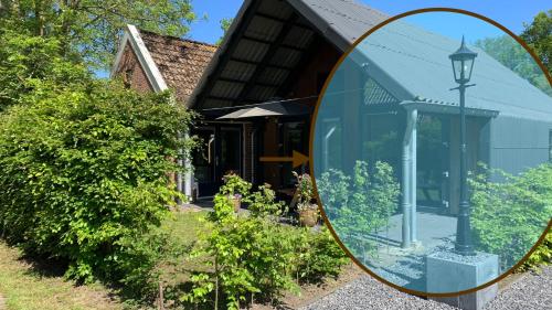 a mirror in front of a house with a street light at JouwvakantiehuisNL - Accommodatie Drentsche Aa in Vries