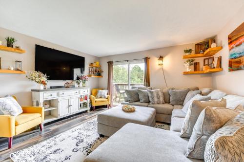 a living room with a couch and a tv at Mtn-View Gem with Hot Tub Access Branson Condo in Branson