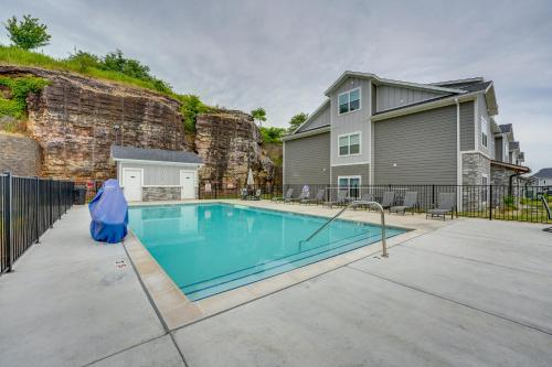 a swimming pool in front of a house at Mtn-View Gem with Hot Tub Access Branson Condo in Branson