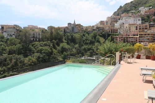 a swimming pool with a view of a city at Taormina Skyline in Taormina