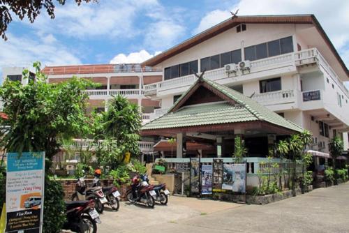 a building with motorcycles parked in front of it at Top North Guest House in Chiang Mai