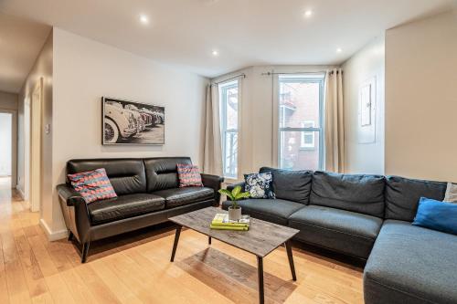 a living room with a couch and a table at Vibrant Le Plateau Escape for Groups Near Metro in Montréal