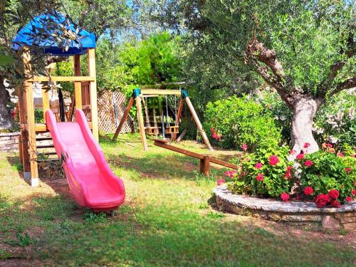 a playground with a slide and a swing at Foinikounta view in Finikounta