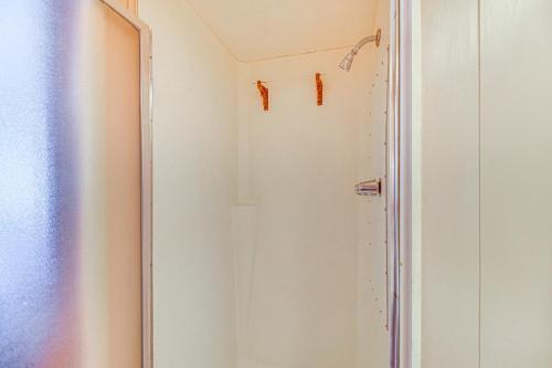 a shower in a bathroom with a white wall at Lakefront Cabin in Jay with Deck, Views and Boat Ramp! in Jay