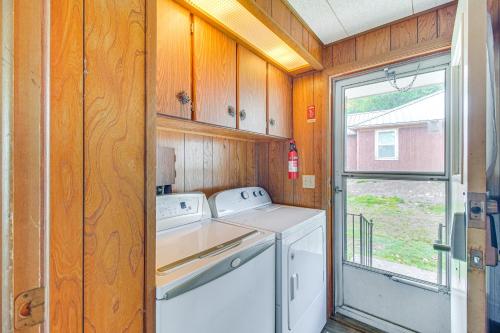 a laundry room with a washer and dryer and a window at Lakefront Cabin in Jay with Deck, Views and Boat Ramp! in Jay