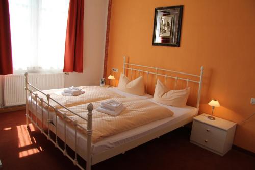 a bedroom with a bed with orange walls at Komforthotel-Restaurant Württemberger Hof in Bad Saulgau