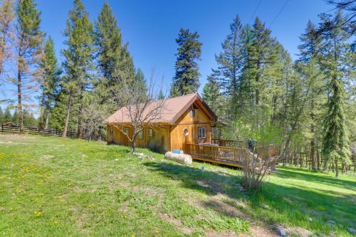 a log cabin in a field with trees at West Kootenai Cabin in Amish Country! in Rexford