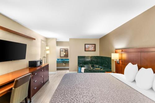 a hotel room with a bed and a bathroom at Econo Lodge Texarkana I-30 in Texarkana - Texas
